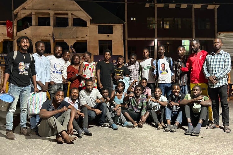 A group of two dozen young activists standing outside in the evening, looking at the camera. LUCHA has built a movement of thousands of young activists — who are working together to educate voters in advance of this year’s upcoming elections. Photo courtesy LUCHA.